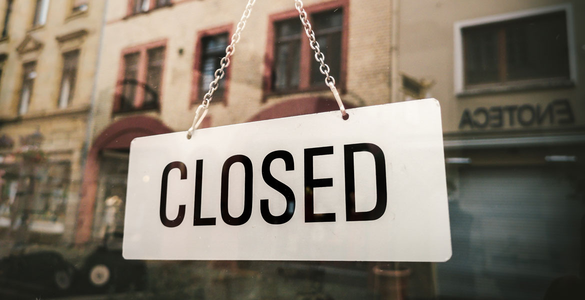 white closed sign hanging on glass